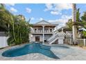 Freeform swimming pool with a spa and spacious patio, creating an inviting outdoor oasis at 12112 Lagoon Ln, Treasure Island, FL 33706
