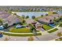 Single-Gathering home on a corner lot with a lake view and lush landscaping at 16340 Treasure Point Dr, Wimauma, FL 33598