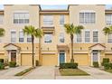 Three-story townhouses with attached garages and lush landscaping at 3117 Bayshore Oaks Dr, Tampa, FL 33611