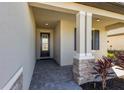 Covered entryway with stone columns and a paved walkway at 5211 Marina Basin Ct, Bradenton, FL 34211