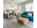 Open concept living space with a modern kitchen and comfortable seating at 690 Fox St, Longboat Key, FL 34228