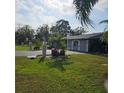 House exterior with palm trees and landscaping at 901 8Th Sw St, Ruskin, FL 33570
