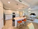 Modern kitchen with white cabinets, quartz countertops, and stainless steel appliances at 10059 Crooked Creek Dr # 102, Venice, FL 34293