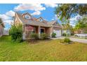 House exterior showcasing a well-maintained lawn and American flag at 10814 Newbridge Dr, Riverview, FL 33579