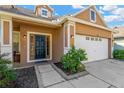 Front entrance with a dark-colored door and nicely landscaped area at 10814 Newbridge Dr, Riverview, FL 33579