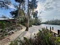 Landscaped backyard with access to a private dock and river at 11554 Monette Rd, Riverview, FL 33569
