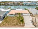 Single-Gathering home with canal access, large yard, and paved driveway at 12350 4Th E St, Treasure Island, FL 33706