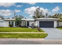 Charming ranch-style home with a modern exterior and well-maintained landscaping at 1448 S Hercules Ave, Clearwater, FL 33764