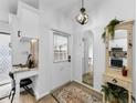 Bright entryway with built-in workspace and mirror at 1725 Pine Ridge E Way # E, Palm Harbor, FL 34684
