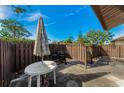 Small patio with table, umbrella, and grill at 1725 Pine Ridge E Way # E, Palm Harbor, FL 34684