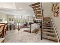 Elegant staircase with a view to the living room and dining area at 18732 Wimbledon Cir, Lutz, FL 33558
