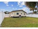 Large backyard with grassy area and white vinyl fence at 1885 Mississippi Ne Ave, St Petersburg, FL 33703