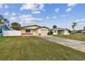 House exterior showcasing a spacious lawn and driveway at 1885 Mississippi Ne Ave, St Petersburg, FL 33703