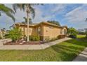 Single story house with tan exterior, landscaping, and walkway at 2019 Acadia Greens Dr # 34, Sun City Center, FL 33573