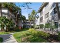 Condo building exterior showcasing landscaping and walkways at 2650 Countryside Blvd # C309, Clearwater, FL 33761