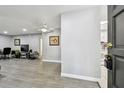 Living room with gray walls, wood-look floors, and comfy armchairs at 2650 Countryside Blvd # C309, Clearwater, FL 33761