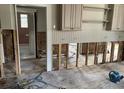 Kitchen undergoing renovation, showing exposed walls and flooring at 331 Pineapple St, Tarpon Springs, FL 34689