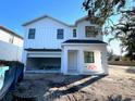 Two-story white house under construction, two-car garage, and partially landscaped yard at 3424 Ohio Ave, Tampa, FL 33611