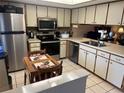 Kitchen features stainless steel appliances and wood table at 38245 Ironwood Pl # 0, Zephyrhills, FL 33542