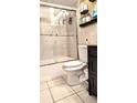 Clean bathroom with a shower/tub combo, toilet and dark-wood vanity at 4214 Trucious Pl, New Port Richey, FL 34652