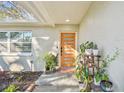 Inviting front entrance with a modern door and potted plants at 4320 63Rd N St, Kenneth City, FL 33709