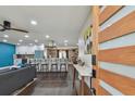 Open living room with a modern kitchen and island visible at 4320 63Rd N St, Kenneth City, FL 33709