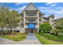 Condo building entrance with landscaping and signage at 5567 Sea Forest Dr # 320, New Port Richey, FL 34652