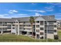 Exterior view of condo building with parking and landscaping at 5567 Sea Forest Dr # 320, New Port Richey, FL 34652