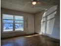 Bright living room with hardwood floors and large windows at 5627 Commonwealth Ave N, St Petersburg, FL 33703