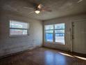 Bright living room with hardwood floors and large windows at 5627 Commonwealth Ave N, St Petersburg, FL 33703