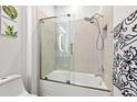 Modern bathroom with a glass shower enclosure and bathtub at 5672 Bay Tide Ct, Land O Lakes, FL 34638
