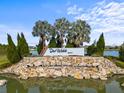 Welcoming entrance to Del Webb Bexley community with pond at 5672 Bay Tide Ct, Land O Lakes, FL 34638