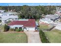 Single-story home with red tile roof, driveway, and fenced backyard at 6004 1St W Ave, Bradenton, FL 34209