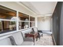 Relaxing screened porch with wicker furniture and a view of the yard at 6004 1St W Ave, Bradenton, FL 34209