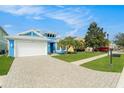 Bright blue house with a white garage door and spacious front yard at 6408 Key Island Ave, Apollo Beach, FL 33572