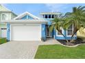 Coastal style home with a white garage door and nicely landscaped yard at 6408 Key Island Ave, Apollo Beach, FL 33572