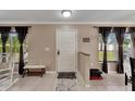 Bright and airy entryway with tile flooring, a half wall, and a bench at 10817 Keys Gate Dr, Riverview, FL 33579