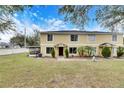 Front view of a two-story townhome with a well-maintained lawn at 10817 Keys Gate Dr, Riverview, FL 33579