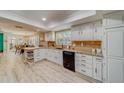 Bright kitchen featuring white cabinets, granite counters, and modern appliances at 11100 141St Way, Largo, FL 33774