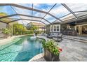 Inviting screened-in pool area with a large patio and outdoor seating at 11911 Mandevilla Ct, Tampa, FL 33626