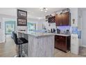 Interior shot of the wet bar with granite countertop and a dark brown wine rack at 18102 Livingston Ave, Lutz, FL 33559