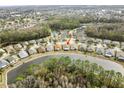 Aerial view of house on a lake in a residential neighborhood at 25237 Lexington Oaks Blvd, Wesley Chapel, FL 33544