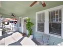 Bright front porch with ceiling fans and two chairs, overlooking the street at 307 W Crest Ave, Tampa, FL 33603