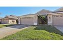 House exterior showcasing a two-car garage and landscaping at 31447 Shaker Cir, Wesley Chapel, FL 33543
