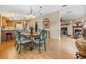 Open dining area with hardwood floors and a charming wooden table at 37539 Gill Ave, Zephyrhills, FL 33541