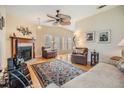 Bright living room with hardwood floors, a fireplace, and comfy seating at 37539 Gill Ave, Zephyrhills, FL 33541