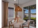 Casual dining area with round table, chairs, and sliding glass doors to backyard at 4177 Feldspar Ln, Spring Hill, FL 34609