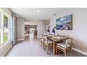 Bright dining area with hardwood floors and a view to the kitchen at 5354 Oxford Gray Rd, Zephyrhills, FL 33541