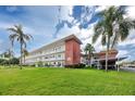 Two-story building with lush lawn and palm trees at 5728 14Th N Ave # 305B, St Petersburg, FL 33710