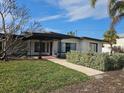 House exterior featuring walkway and landscaping at 8300 Boca Ciega Dr, St Pete Beach, FL 33706